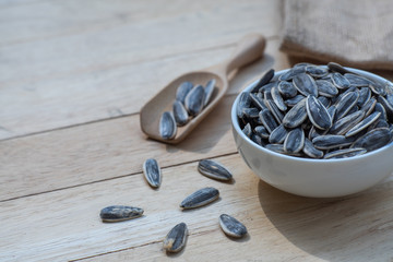Poster - Sunflower seed, snack, in white bowl on wood table