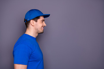 Wall Mural - Close up side profile photo express specialist he him his delivery boy beaming smile self-confident took deliver order offer buy buyer wear blue t-shirt cap corporate suit isolated grey background