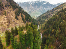 Overcast Sky Over Green Slopes Of Himalayas And Fast Stream Near Manali Village In Himachal Pradesh, India 