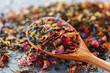 © fotofabrika - Handful of natural tea on a wodden surface