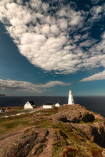 Dramatic Sky Over A White Lighthouse At The Edge Of A Cliff. Cape Spear National Historic Site, St Johns Newfoundland. 