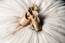 Pointe Shoes. Peach Shoes, Ballet Shoes With Ribbons On A White Tutu In A Dance Studio. Advertising Ballet School. Professional Ballerina Outfit.
