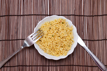 Instant noodles in a white bowl. Appetizing Egg Noodles