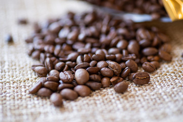 roasted brown coffee beans scattered close-up, background, texture