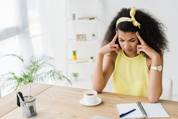 Wall Mural - exhausted curly brunette african american woman having headache