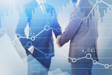 Wall Mural - Two businessmen shaking hands, graphs