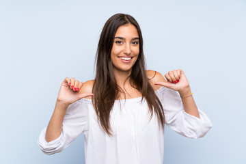 Young woman over isolated blue background proud and self-satisfied