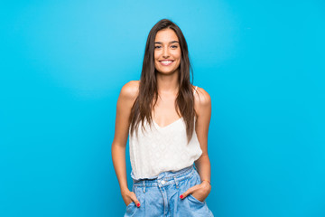 young woman over isolated blue background laughing