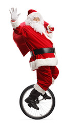 Wall Mural - Santa claus riding a unicycle, waving and carrying a sack of presents