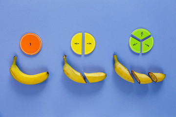 Wall Mural - Сolorful math fractions and bananas as a sample on violet background. Interesting math for kids. Education, back to school concept. Geometry and mathematics materials.