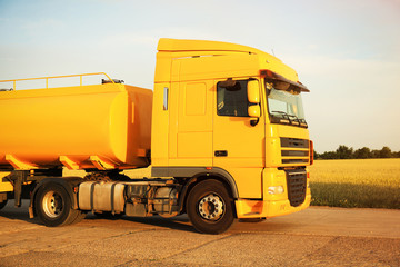 Modern yellow truck parked on country road