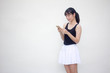 © tiniroma - Portrait of thai adult beautiful girl black shirt white skirt using her smart phone
