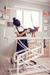 © zinkevych - Woman wearing uniform drying dog standing on the table
