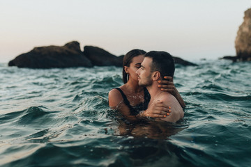 lovely couple kissing in the sea