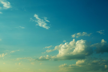 Large heavy clouds slowly float across the blue beautiful sky. Stunning landscape and view.