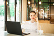 © Haibullaev - girl in cafe at lunch works behind a laptop