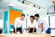 © NVB Stocker - Teamwork concept. Three business people discussing and looking on laptop together