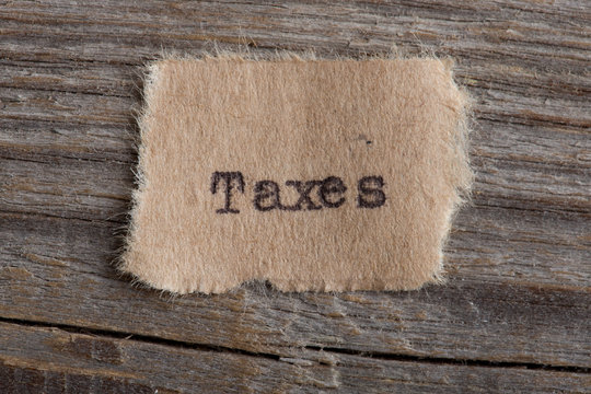 Taxes typed text on a paper, real estate concept
