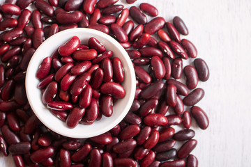 Wall Mural - Red beans in white bowl on wooden background.