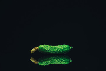 Aufkleber - Close up Beautiful  fresh cucumbers and yellow flower on a black glass table dark background.