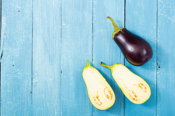 Wall Mural - eggplants on blue wood table