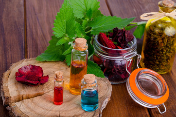 Canvas Print - Glass bottles of aroma essential oil on wooden background, image for alternative therapy medicine