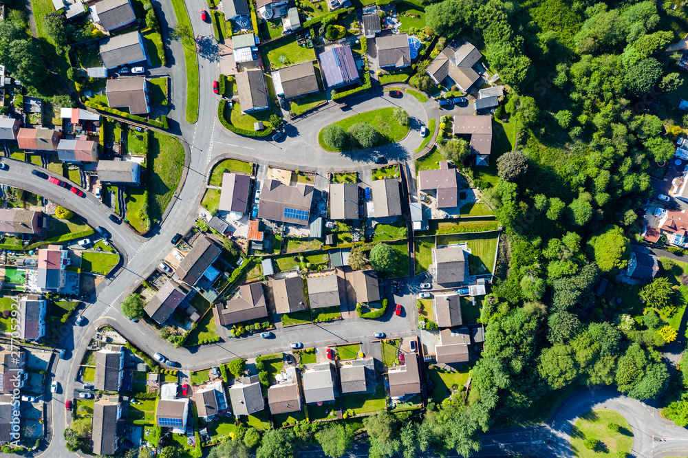Aerial drone view of small winding sreets and roads in a residential area of a small town - obrazy, fototapety, plakaty 