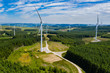 © whitcomberd - Aerial drone view of turbines at a large onshore windfarm on a green hillside (Pen y Cymoedd, Wales)