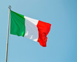 © giodilo - Italian national flag vawing in the wind with blue sky used as background