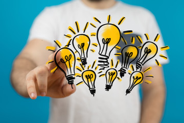  holding illuminated light bulb, idea, innovation and inspiration concept.