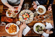 © Michael Marquand - group of friends eating dinner at a seafood restaurant