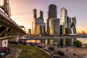 Moscow-City skyscrapers and bridge over Moskva River at sunset, Russia. Moscow-City is a modern business district in the Moscow center. Cityscape of Moscow with office and residential tall buildings.