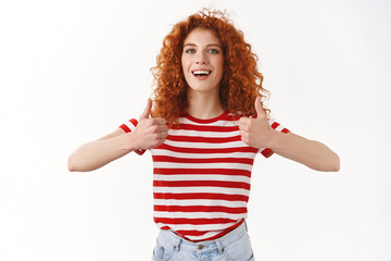 I agree good choice. Attractive charismatic satisfied redhead curly-haired female approve fantastic work hairdresser show thumbs up smiling broadly express like approval good attitude, recommend