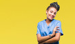 Young braided hair african american girl professional nurse over isolated background happy face smiling with crossed arms looking at the camera. Positive person.