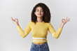 © Cookie Studio - Breathing practice brings peace soul. Charming relaxed carefree meditation stylish girl curly-haired brunette close eyes inhale air raise hands lotus nirvana pose exercise yoga taking break city rush