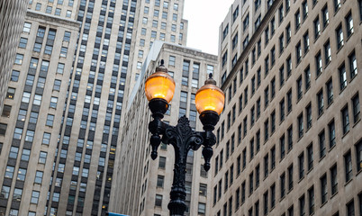 Fototapete - Chicago city downtown, Illuminated street lamps on skyscrapers background