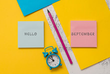 Text Sign Showing Hello September. Business Photo Text Eagerly Wanting A Warm Welcome To The Month Of September Notepads Marker Pen Colored Paper Sheets Alarm Clock Wooden Background
