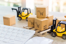 Mini Forklift Truck Load Cardboard Boxes With Text Online Shopping And Symbol On Wood Pallet And Keyboard Nearby. Logistics And Transportation Management Ideas And Industry Business Commercial Concept