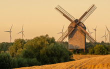 Wooden Windmill On A Summer Field During Sunset