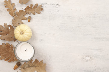 Poster - Autumnal still life with oak leaves, acorns, pumpkin and candle