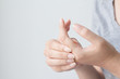 © jajam_e - Young woman suffering from pain in hands and massaging her painful hands. Health care and medical concept.