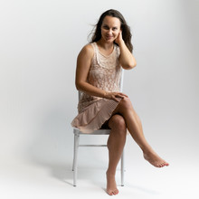 Horizontal Portrait Full Length Sitting On A White Chair On A White Background Beautiful Pretty Woman In A Fashionable Light Pink Dress, In Various Poses. Stylish Trendy Youth.