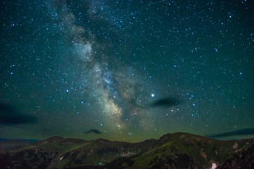 milky way at night over the mountains
