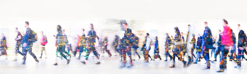 Beautiful motion blur of walking people in train station. Early morning rush hours, busy modern life concept. Ideal for websites and magazines layouts