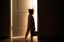 Little Girl Opens The Door To The Light In Darkness