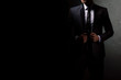 © Marina Dobryakova - Young handsome successful and confident bearded business man in a suit. Isolated on dark background, copy space.