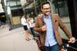© NDABCREATIVITY - Happy businessman riding bicycle to work in morning