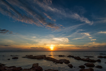 Wall Mural - The rock on the sea with sunset sky