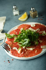 Poster - Homemade beef carpaccio with cheese and arugula