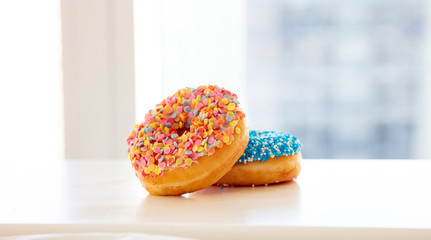 Wall Mural - Doughnuts on white color table. Closeup view